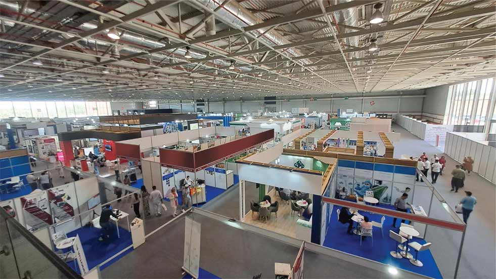 an indoor trade show or exhibition hall with various booths and attendees